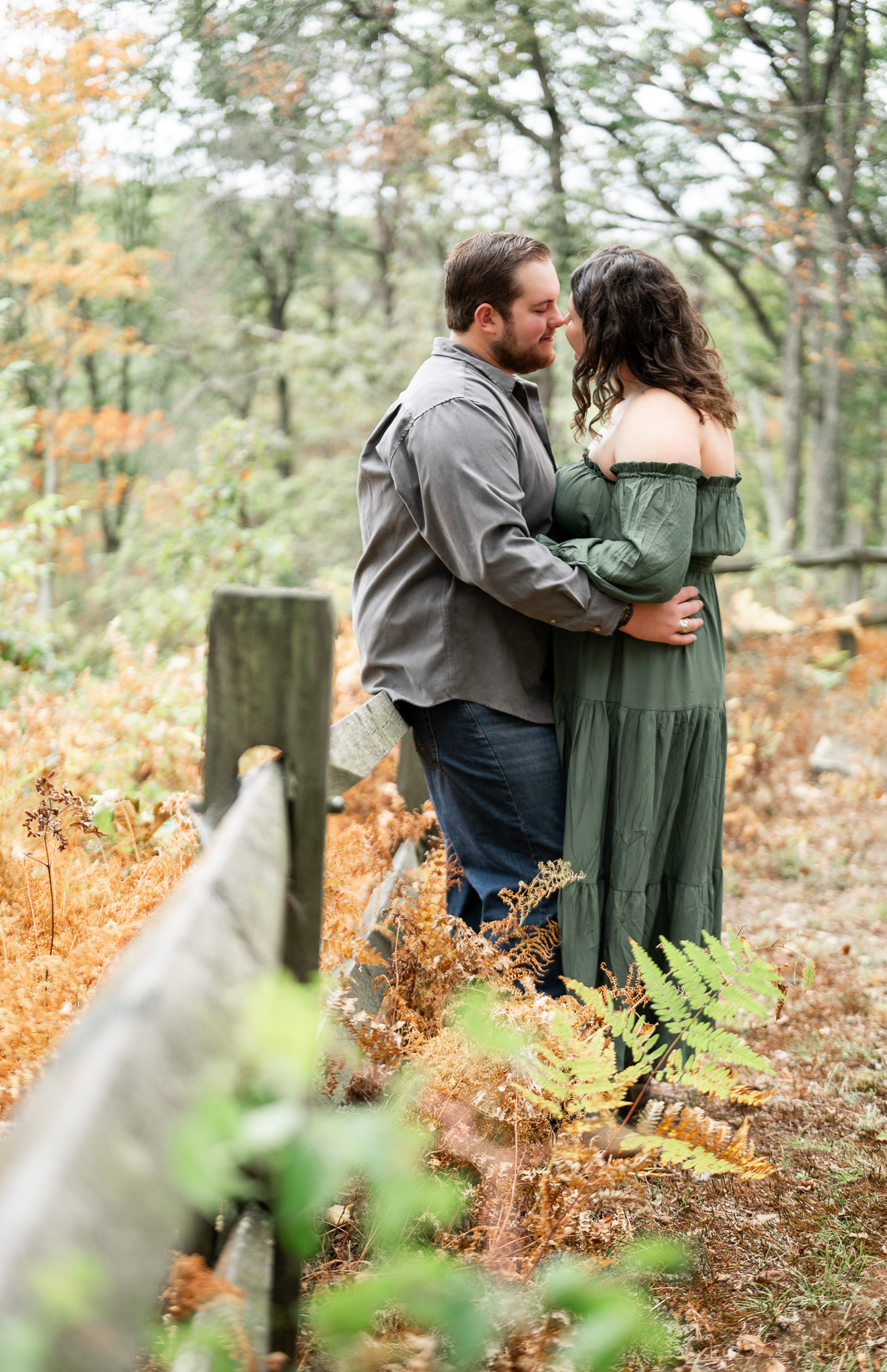 intimate engagement photo against a fence